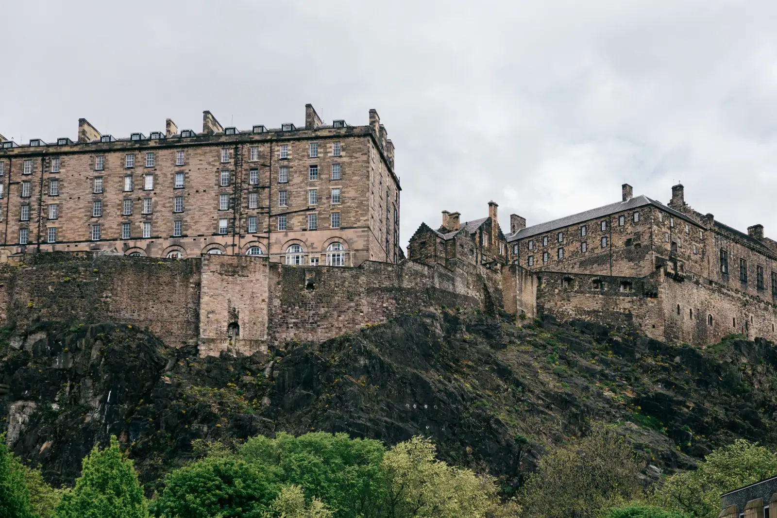 Edinburgh Castle rising on its rocky crag above the treetops